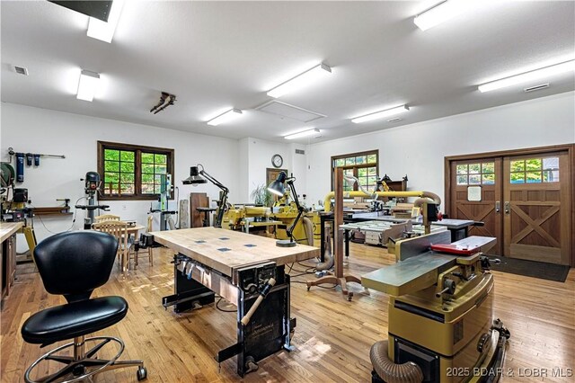 interior space with visible vents, a workshop area, and light wood-style flooring