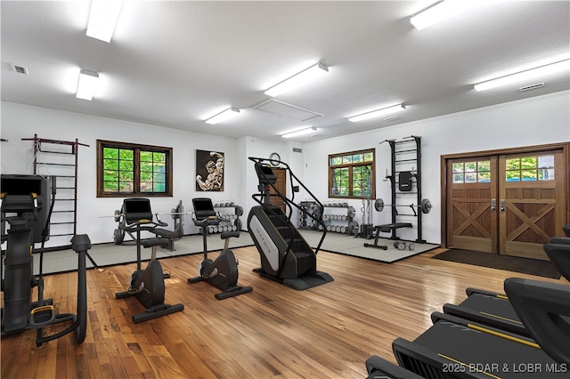 exercise room with visible vents and wood finished floors