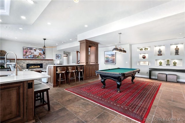 game room featuring baseboards, a lit fireplace, recessed lighting, billiards, and a sink