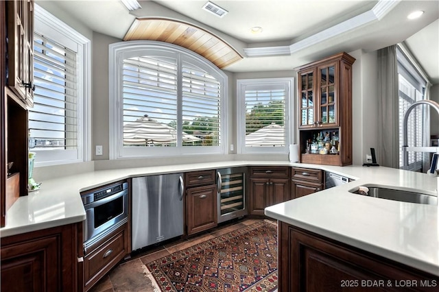 kitchen with visible vents, oven, wine cooler, light countertops, and refrigerator