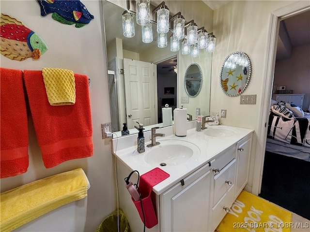 bathroom featuring ceiling fan, double vanity, and a sink