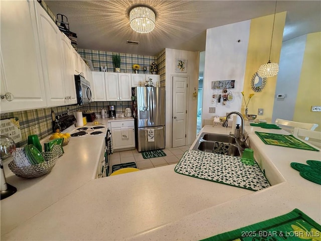 kitchen with visible vents, a sink, white cabinetry, appliances with stainless steel finishes, and light countertops