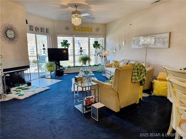 living area with carpet floors and ceiling fan