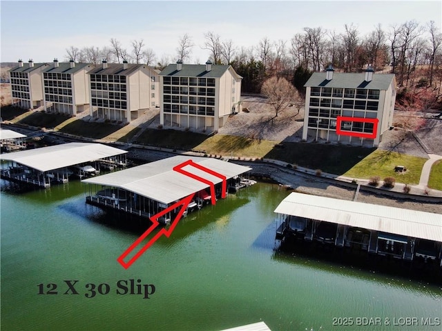 dock area with boat lift and a water view