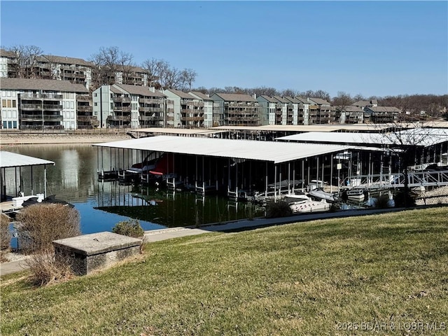 dock area with a water view and a lawn