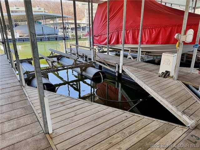 view of dock featuring a water view and boat lift