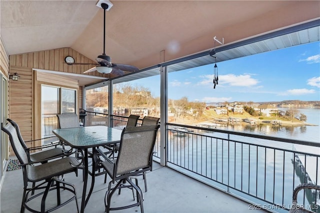 balcony with a water view and ceiling fan