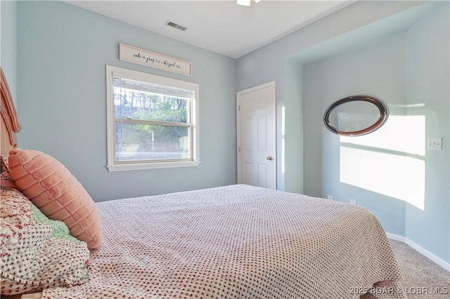 bedroom featuring visible vents, baseboards, and carpet floors