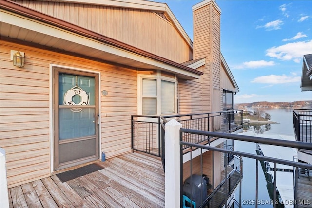 property entrance featuring a water view and a chimney