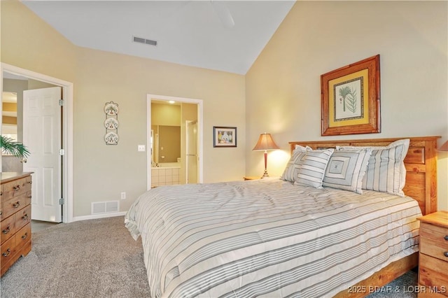 bedroom with lofted ceiling, visible vents, ensuite bathroom, and light carpet