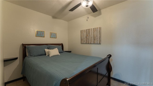 tiled bedroom featuring ceiling fan