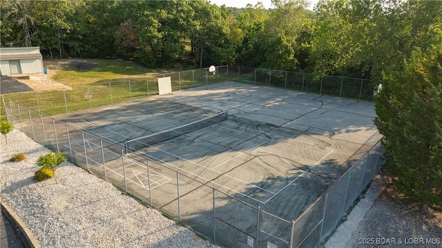 view of swimming pool featuring fence