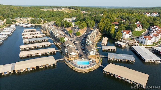 aerial view with a forest view and a water view