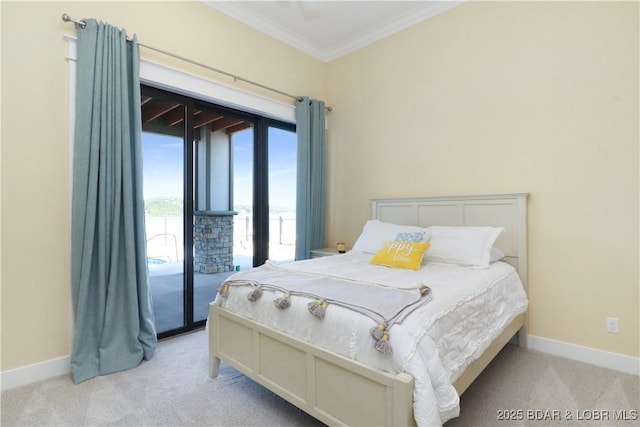 carpeted bedroom featuring access to exterior, baseboards, and ornamental molding