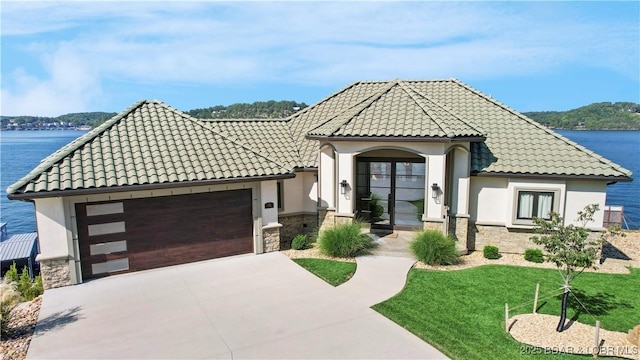 view of front of property with a garage, stone siding, and stucco siding