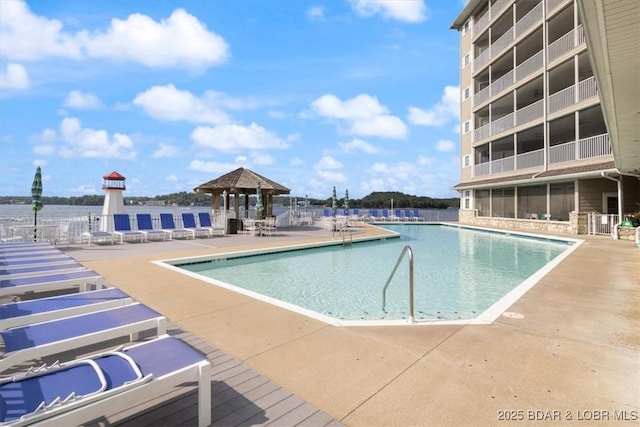 community pool with a gazebo and a patio area