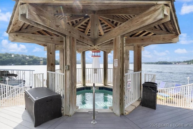 wooden terrace featuring a water view