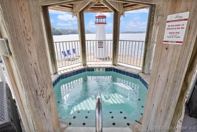 view of swimming pool with an indoor in ground hot tub