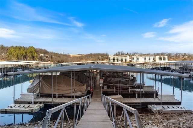 view of dock with boat lift and a water view