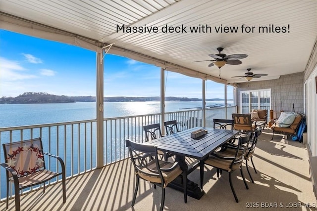 view of patio / terrace featuring a water view, ceiling fan, and outdoor dining space