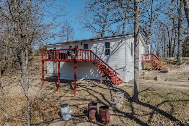 exterior space featuring stairs and a wooden deck