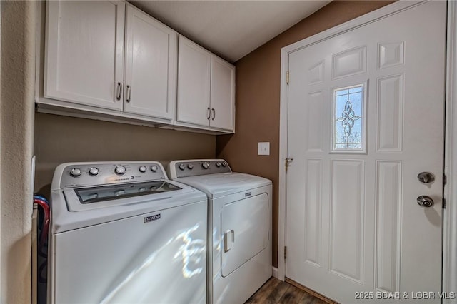 laundry room featuring cabinet space, dark wood finished floors, and washer and clothes dryer