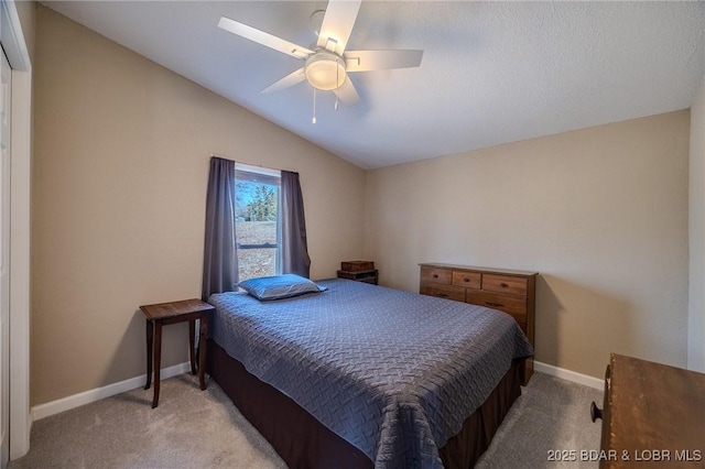 carpeted bedroom with lofted ceiling, baseboards, and ceiling fan