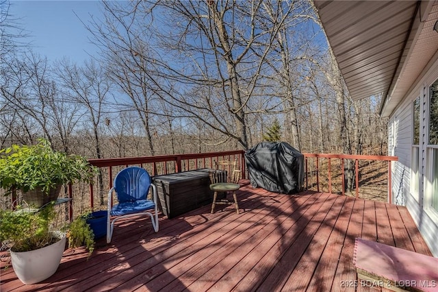 wooden terrace with a grill