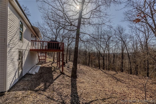 view of yard featuring a wooden deck and stairs