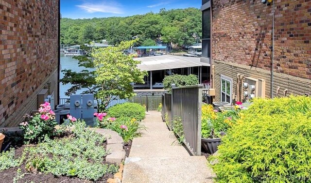 view of property exterior featuring fence and brick siding