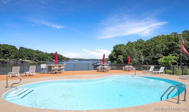 community pool featuring a patio and fence