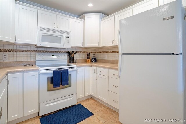 kitchen featuring backsplash, white appliances, white cabinetry, and light countertops