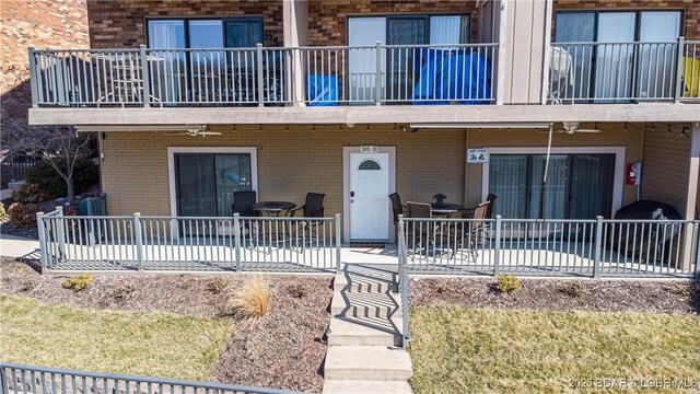 doorway to property featuring a patio area and brick siding