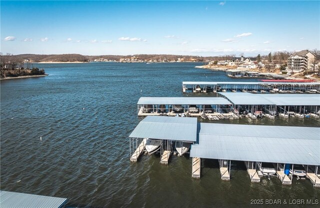 view of dock featuring boat lift and a water view