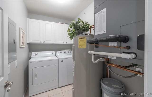 laundry area with light tile patterned floors, cabinet space, washer and dryer, and electric water heater