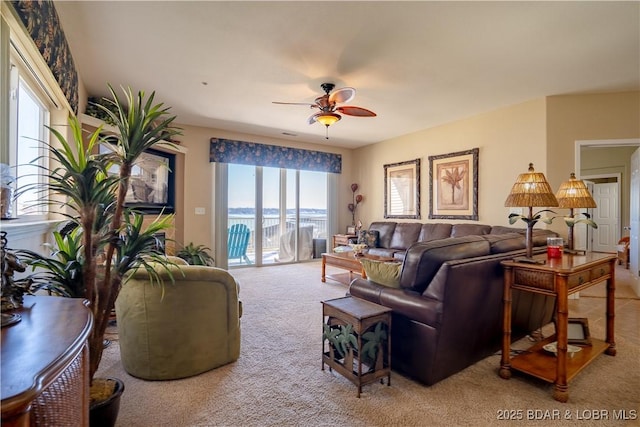 carpeted living area featuring ceiling fan