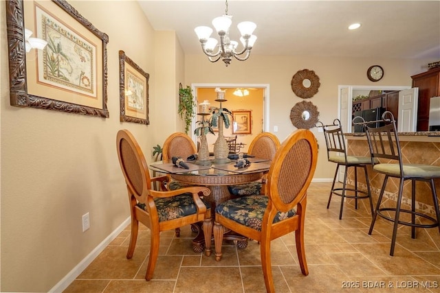 dining space featuring a chandelier, recessed lighting, and baseboards