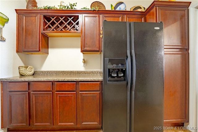 kitchen with light countertops and black fridge