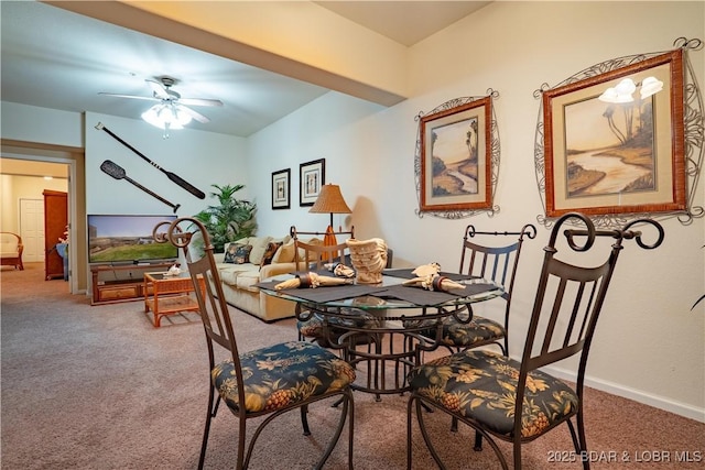 dining space featuring carpet flooring, baseboards, and ceiling fan