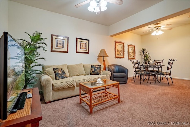 carpeted living room featuring baseboards and a ceiling fan