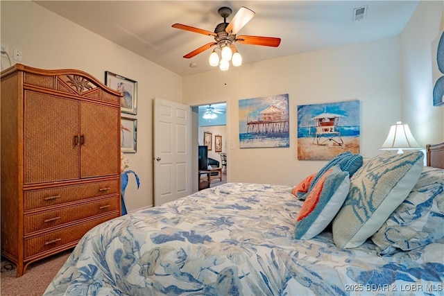 bedroom with visible vents, a ceiling fan, and carpet floors