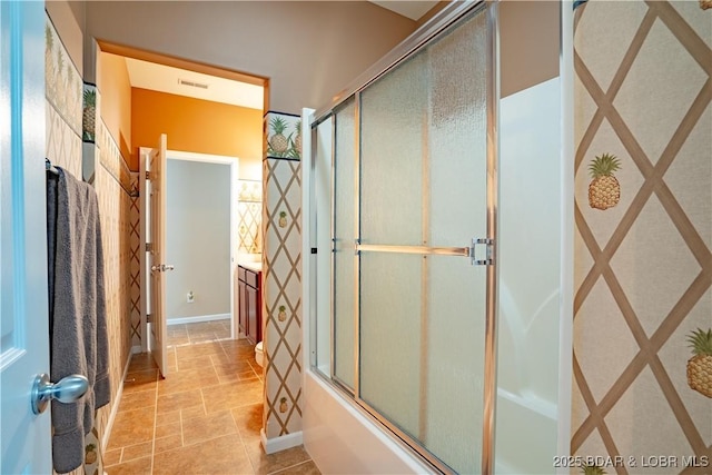 bathroom featuring visible vents, enclosed tub / shower combo, vanity, and stone finish floor