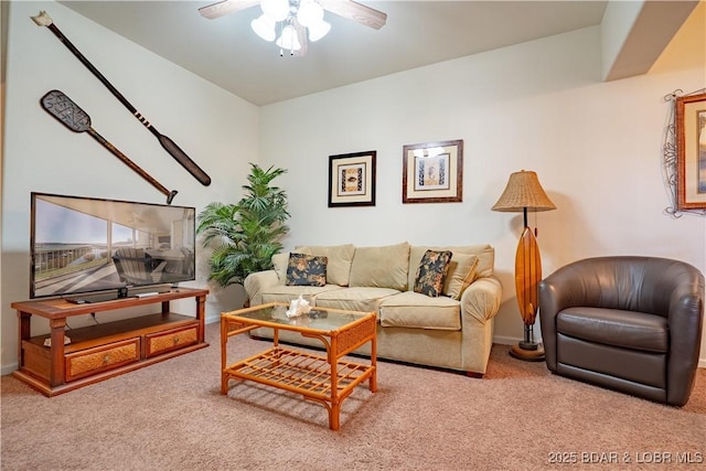 carpeted living area with baseboards and a ceiling fan