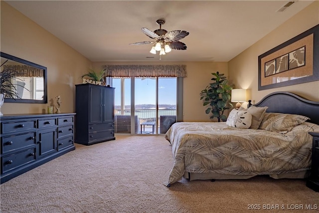 bedroom featuring visible vents, light carpet, ceiling fan, and access to outside