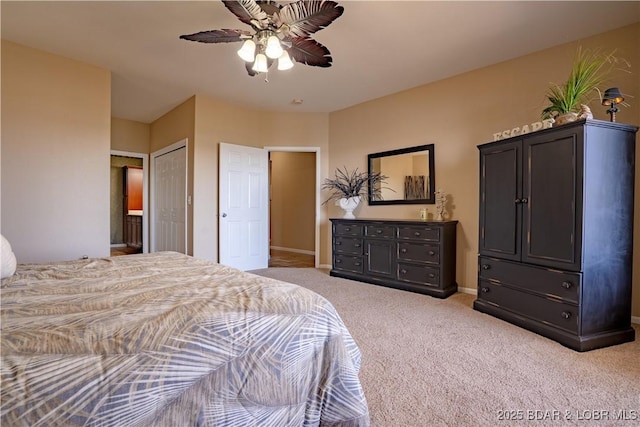 carpeted bedroom featuring a closet, ceiling fan, and baseboards