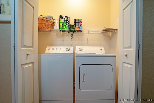 washroom featuring washing machine and dryer and laundry area