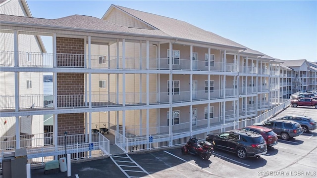 view of building exterior with uncovered parking