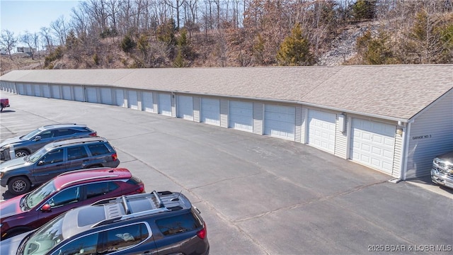 view of car parking featuring community garages