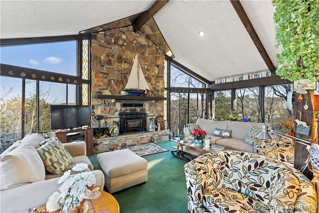 carpeted living room with beam ceiling, a textured ceiling, a stone fireplace, and high vaulted ceiling