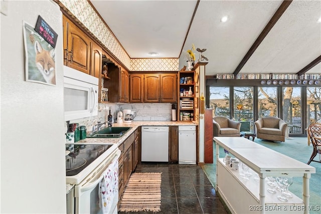 kitchen featuring open shelves, wallpapered walls, light countertops, white appliances, and a sink